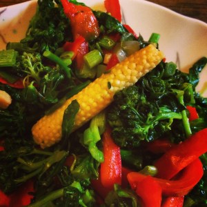 Here's a baby corn, stir-fried with broccoli, green onions, and part of a red pepper. 